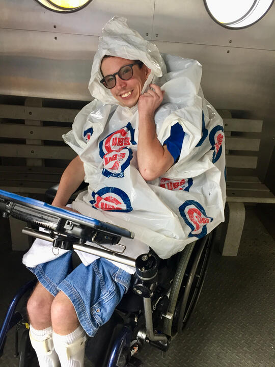 Untitled Ryan grinning in a Cubs poncho