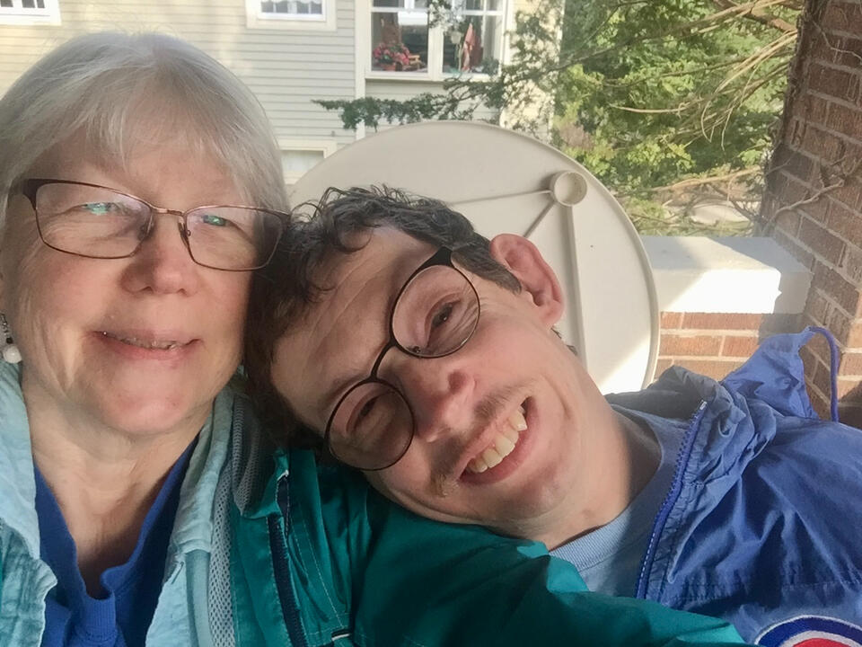 Barb and Ryan smiling on the porch swing