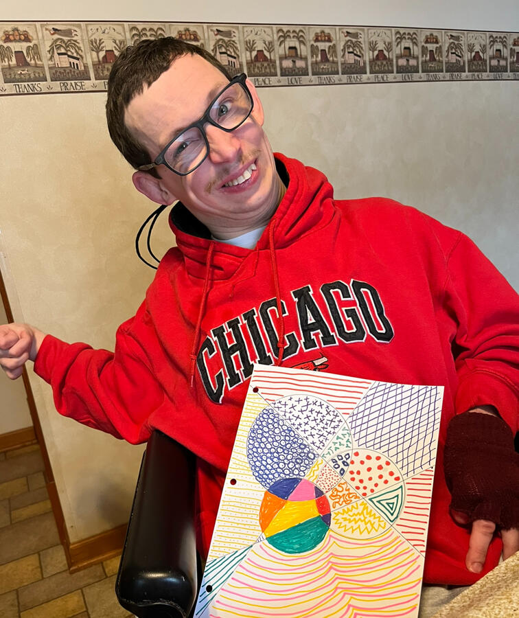 Ryan showing a colorful abstract drawing
