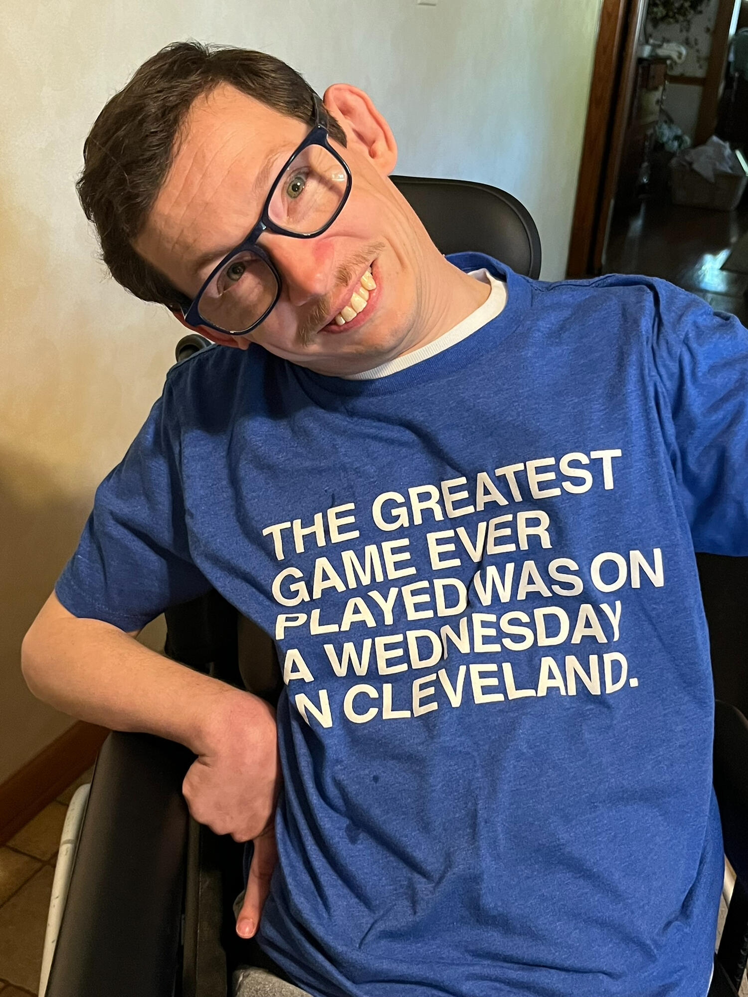 Ryan in a Cubs T-shirt that says "The Greatest Game Ever Played Was on a Wednesday in Cleveland"